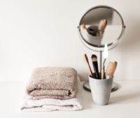 photo of makeup brushes, mirror and towels folded up