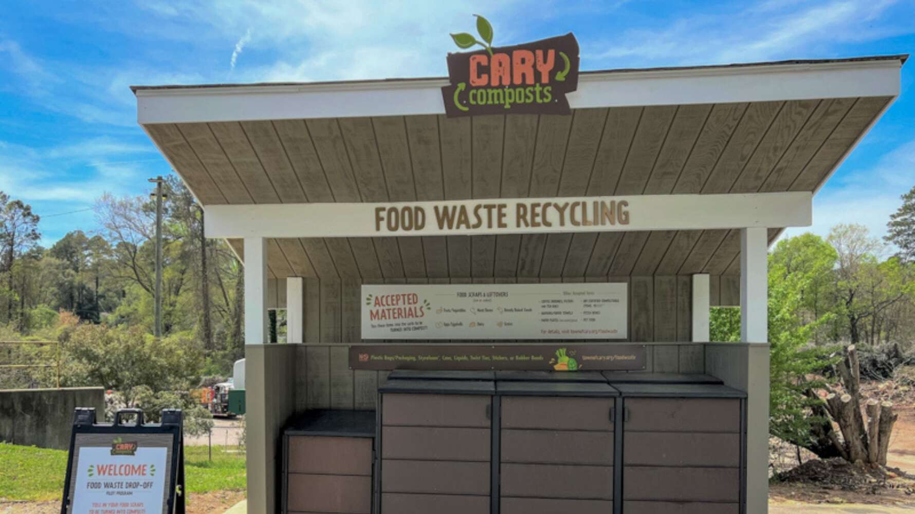 Picture of the food waste drop off in Cary, NC, looks like a shed with a nice sign and bins for food