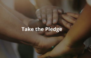 multiple hands put together in the middle with the words "Take the pledge" over the hands in white