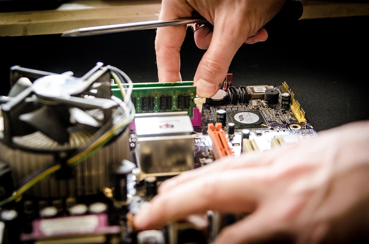 person repairing a computer part