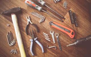 Photo of a collection of hand tools on a wooden table