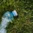 Photo of crushed plastic bottle on grass.