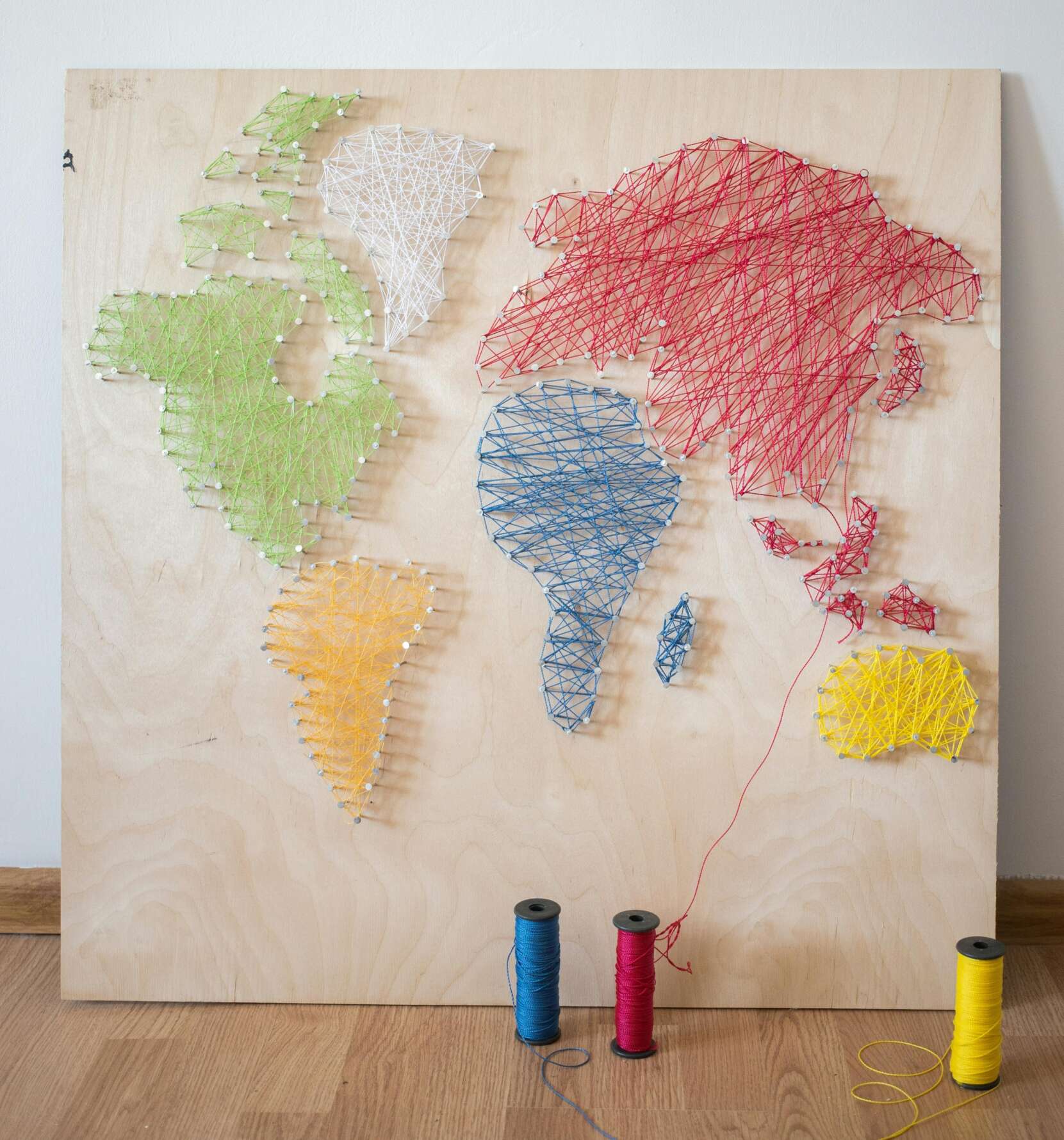 Photo of world map made of string art