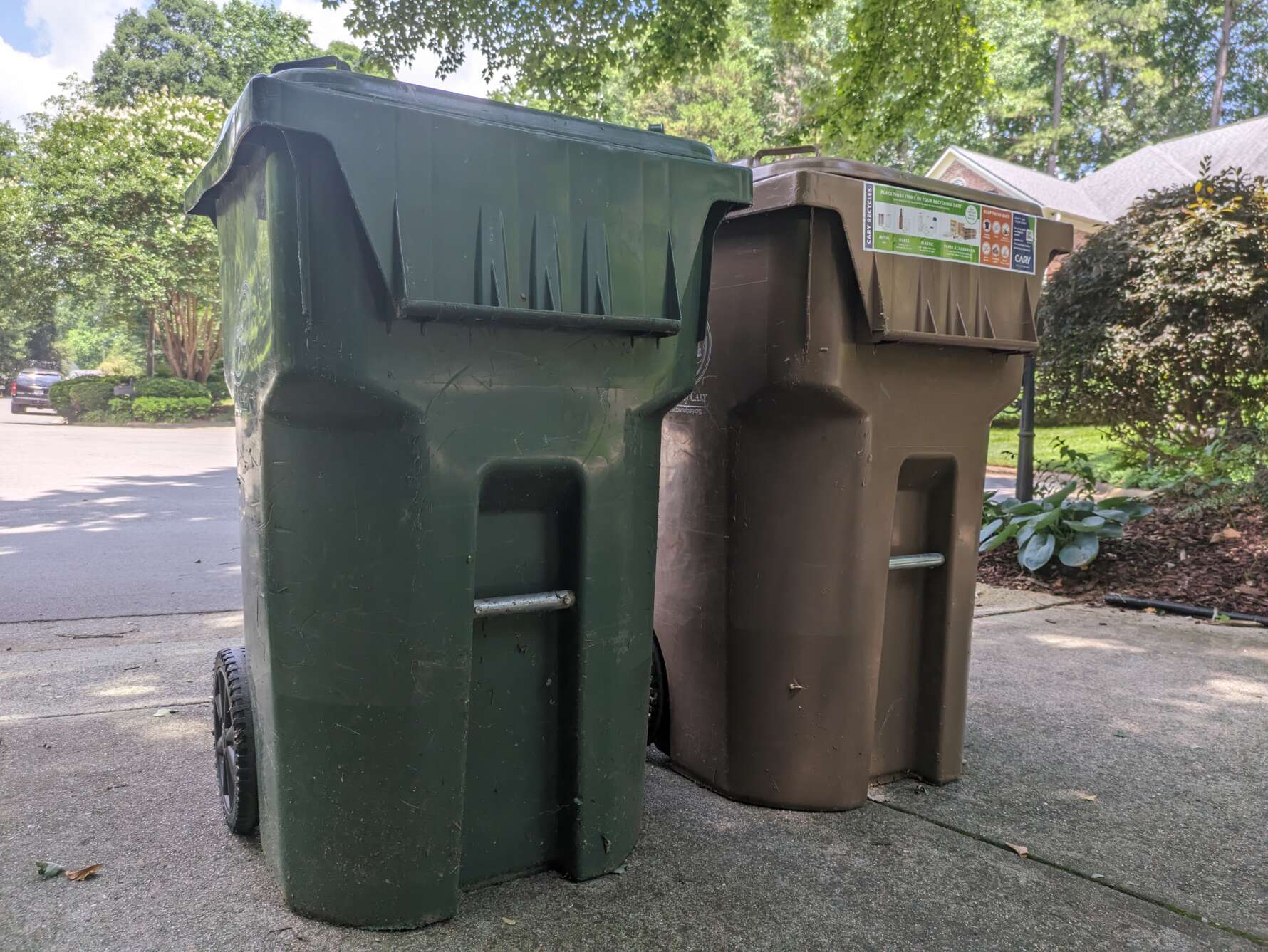 picture of a large rolling trash bin and recycling bin.